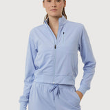 Woman wearing a light blue tracksuit on a white background