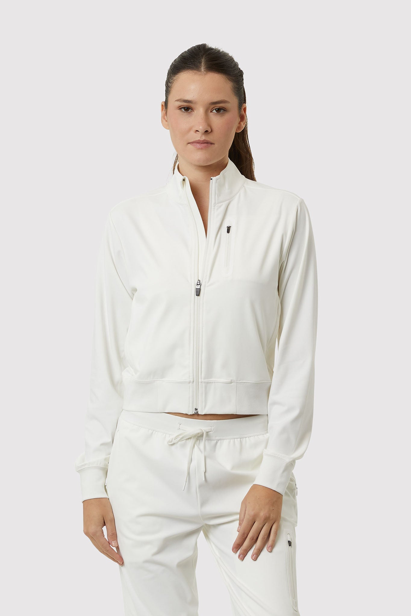 Woman wearing a white tracksuit on a white background