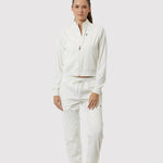 Person wearing a white tracksuit on a white background