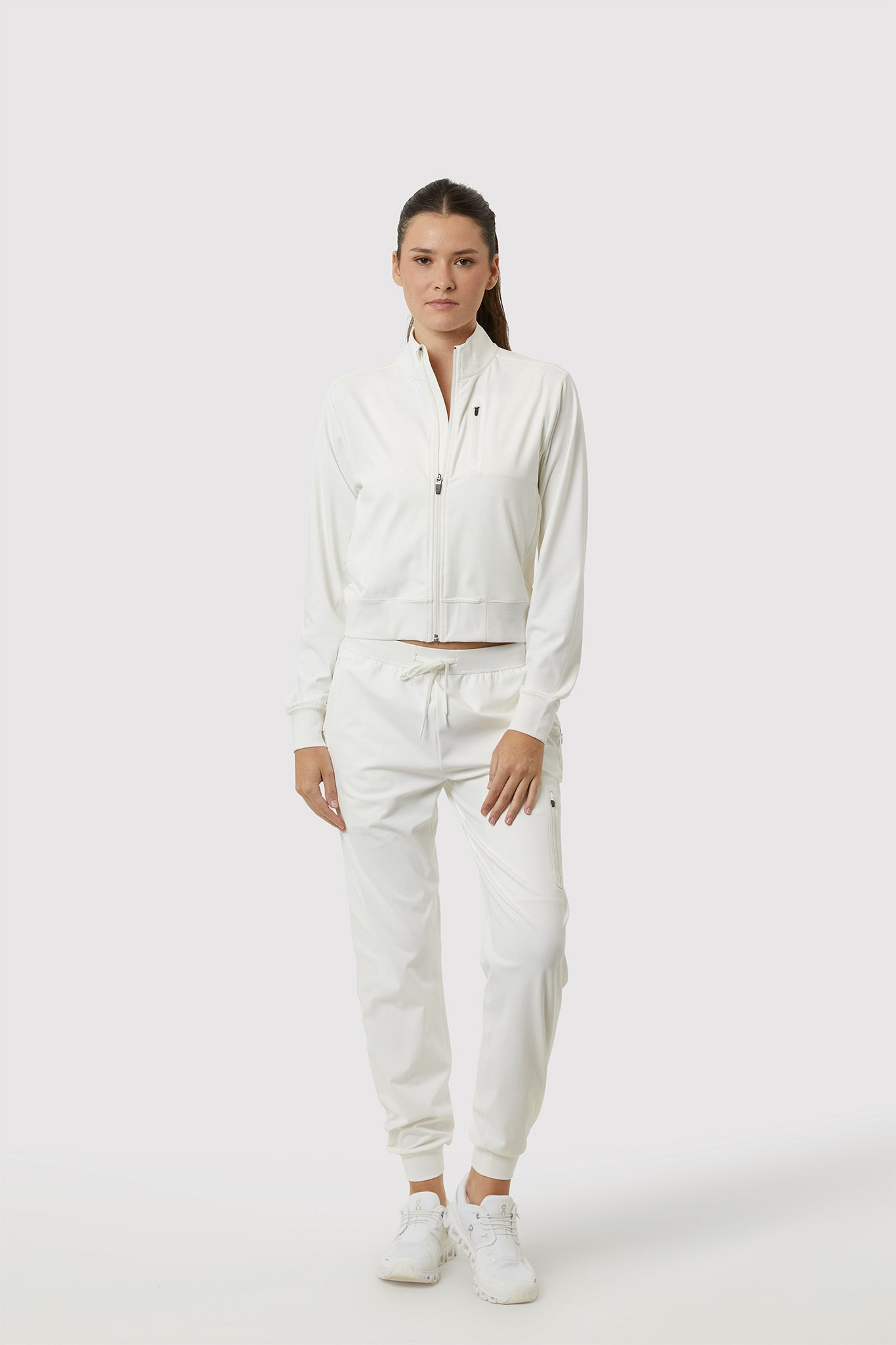 Person wearing a white tracksuit on a white background
