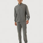 Man wearing a gray tracksuit on a white background