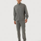 Man wearing a gray tracksuit on a white background