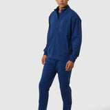 Man wearing a blue tracksuit on a white background