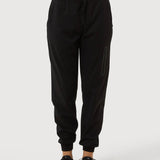 Person wearing black jogger pants on a white background