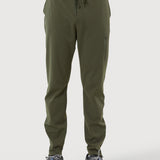Person wearing olive green jogger pants on a white background