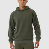 Man wearing a green hoodie and pants on a white background