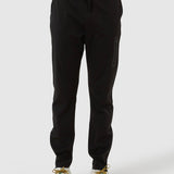 Black jogger pants worn by a person on a white background