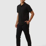 Man wearing a black polo shirt and pants on a white background