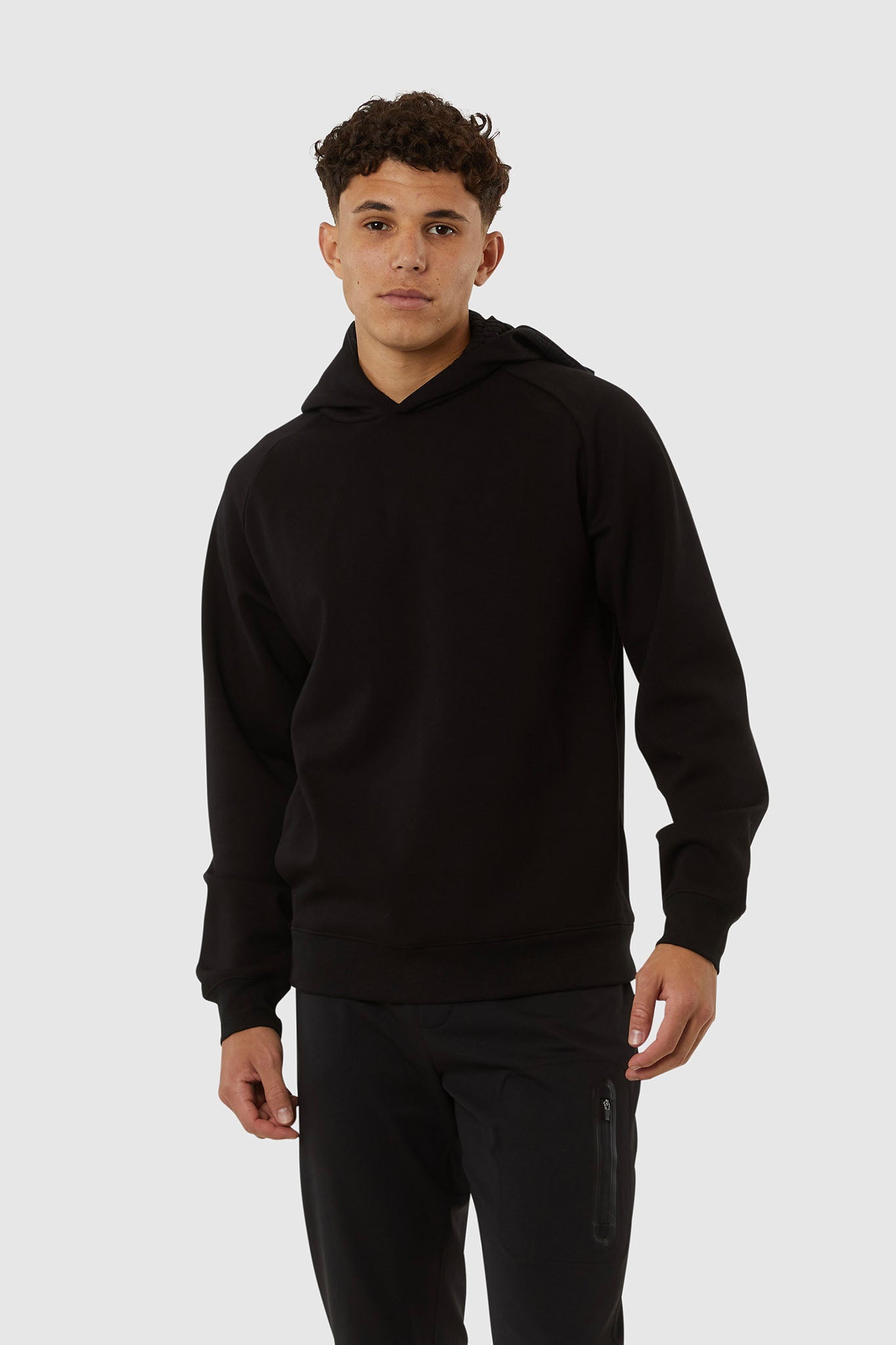 Person wearing a black hoodie on a white background