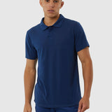 Man wearing a blue polo shirt and pants on a white background