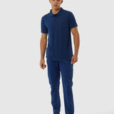 Man wearing a blue polo shirt and pants on a white background