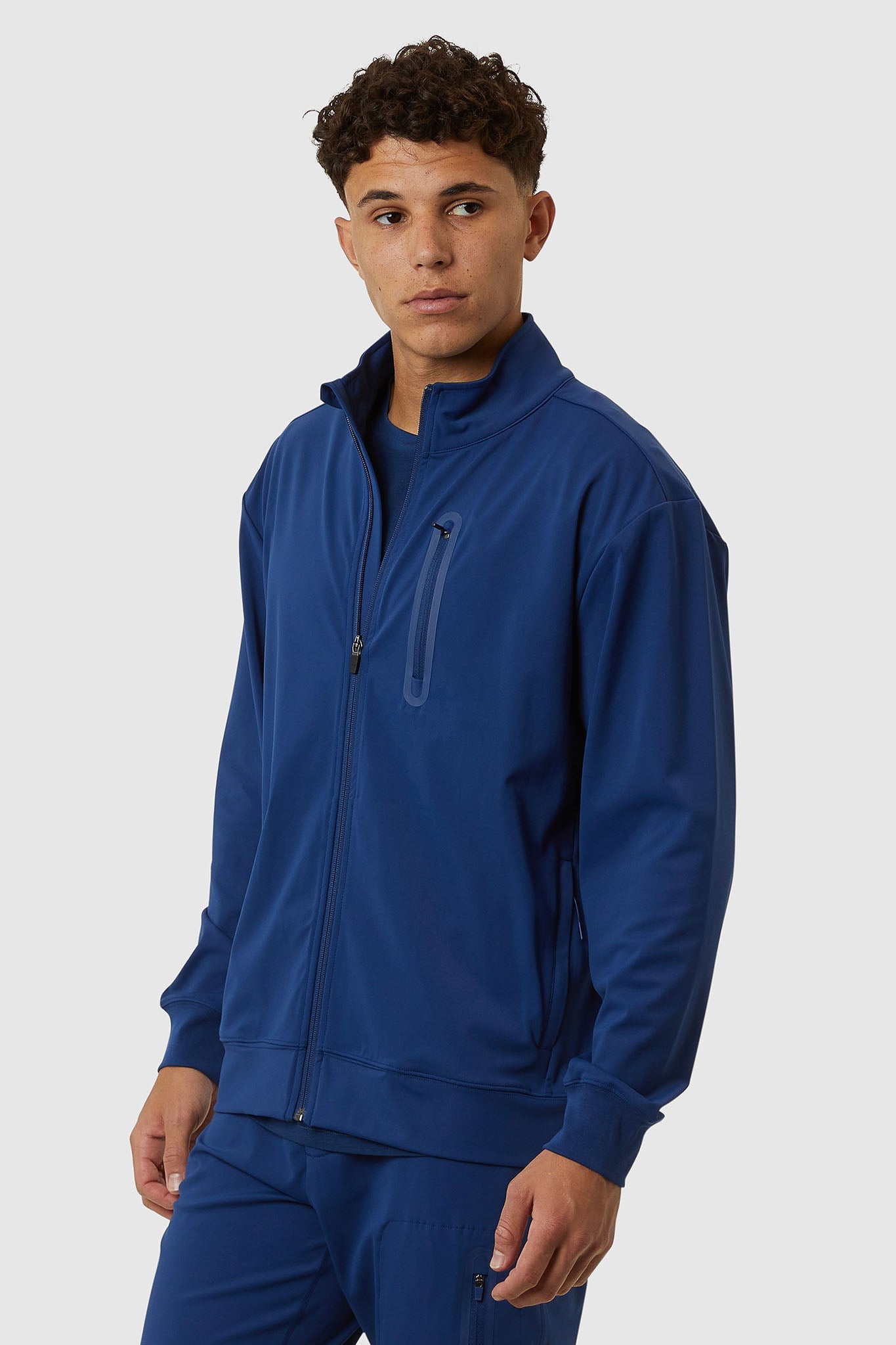 Man wearing a blue tracksuit on a white background