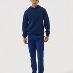 Person wearing a blue tracksuit on a white background