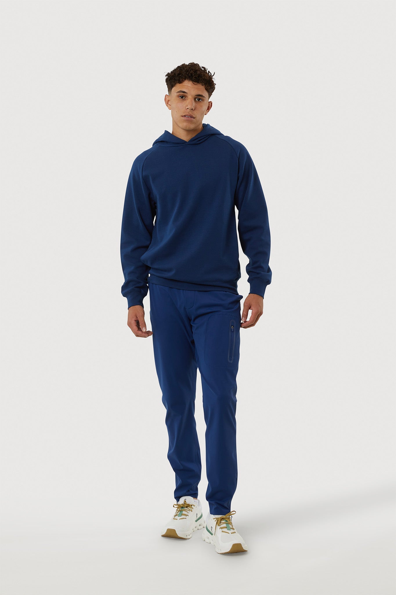 Person wearing a blue tracksuit on a white background