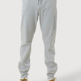 Light gray jogger pants worn by a person on a white background