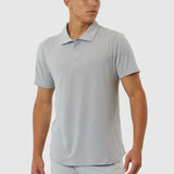 Man wearing a light gray polo shirt and pants on a white background