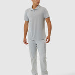 Man wearing a gray polo shirt and pants on a white background