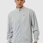 Man wearing a light gray tracksuit on a white background