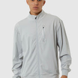 Man wearing a light gray tracksuit on a white background