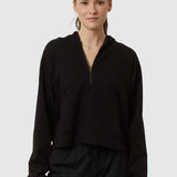 Person wearing a black outfit on a white background