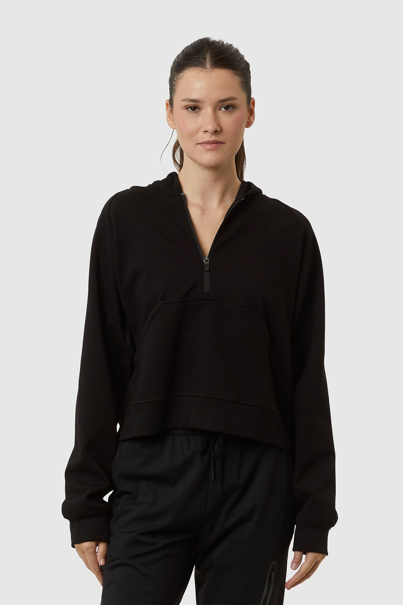 Person wearing a black outfit on a white background