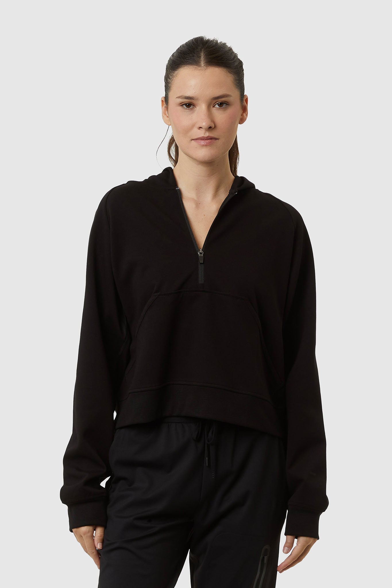 Person wearing a black outfit on a white background