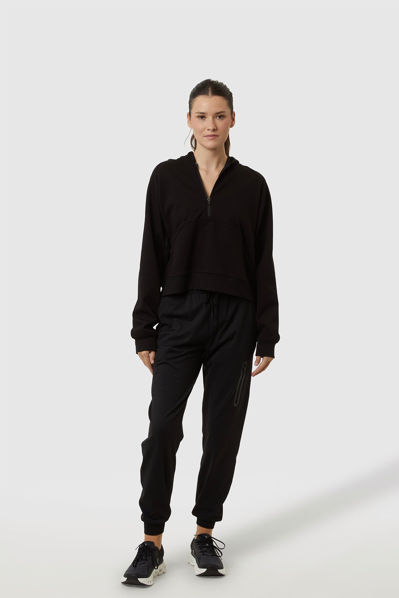 Person wearing a black outfit on a white background