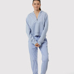 Woman wearing a light blue tracksuit on a white background