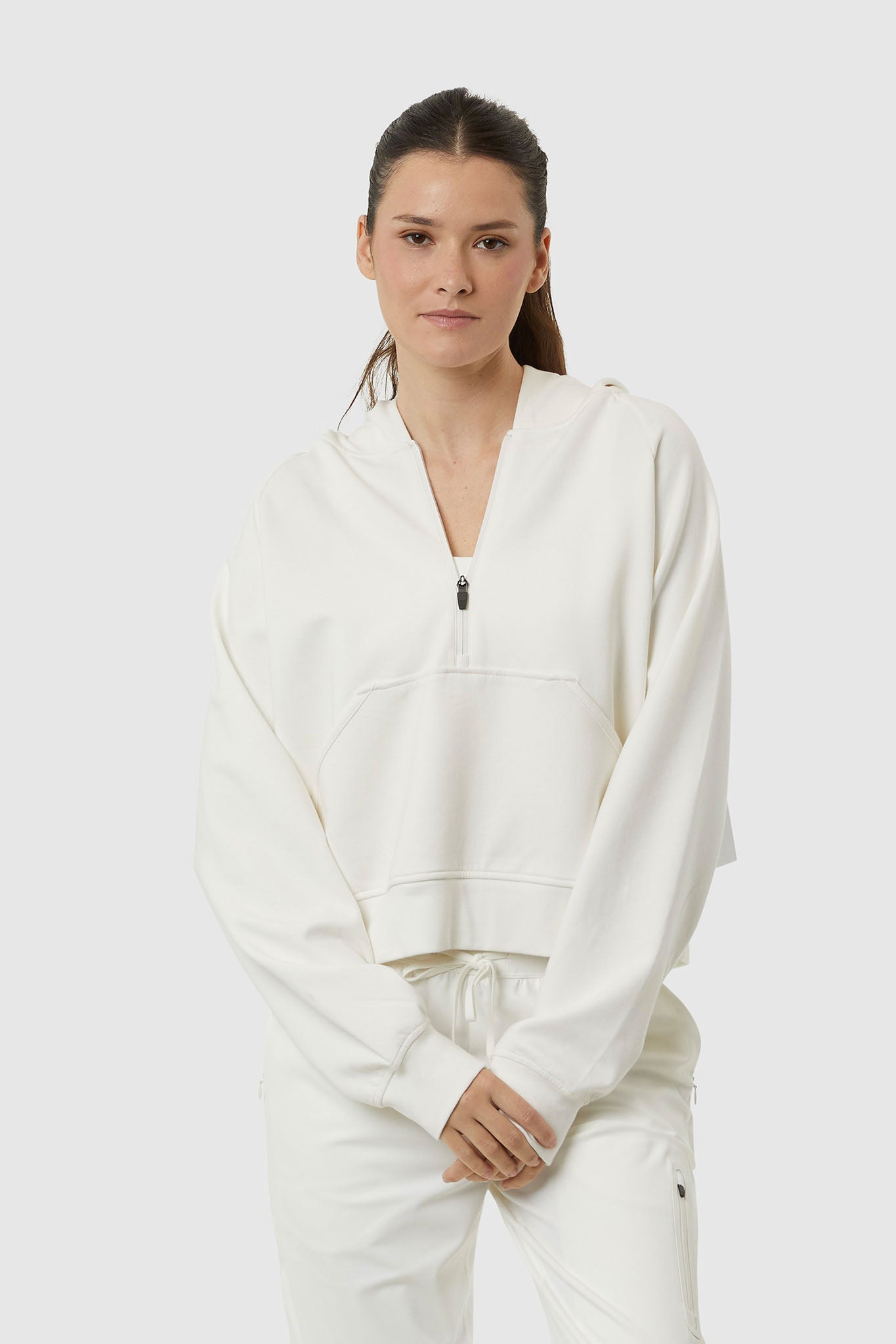 Woman wearing a white tracksuit on a white background