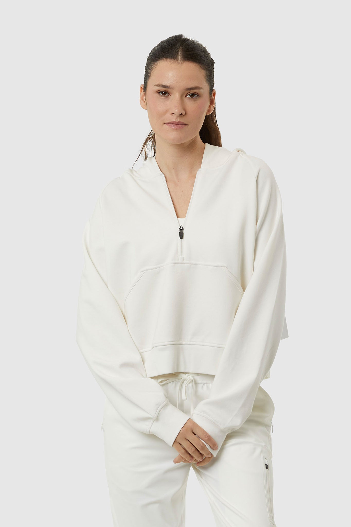 Woman wearing a white tracksuit on a white background