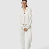 Person wearing a white outfit on a white background