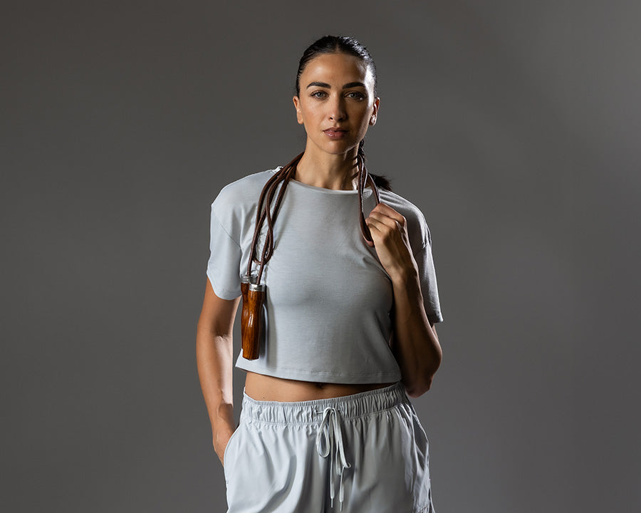Woman holding a jump rope against a gray background